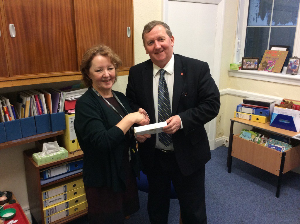 Alex Rowley hands over a gift and thanks Mrs Quinn for her service to Cowdenbeath and Fife
