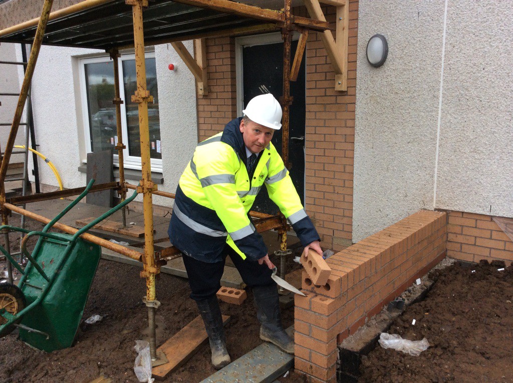 Putting in the final brick at council site in Cowdenbeath